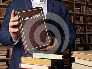 GUN LAWS book in the hands of a jurist. Gun control is one of the most divisive issues in AmericanÃÂ politics photo